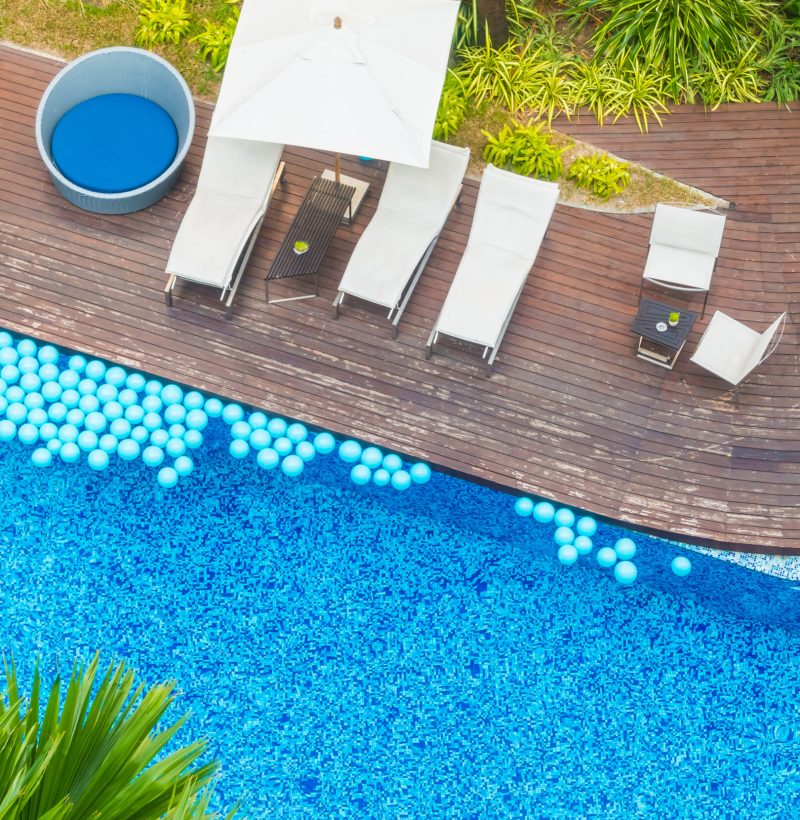 Aerial view of Beautiful luxury hotel swimming pool resort with umbrella and chair - Boost up color processing