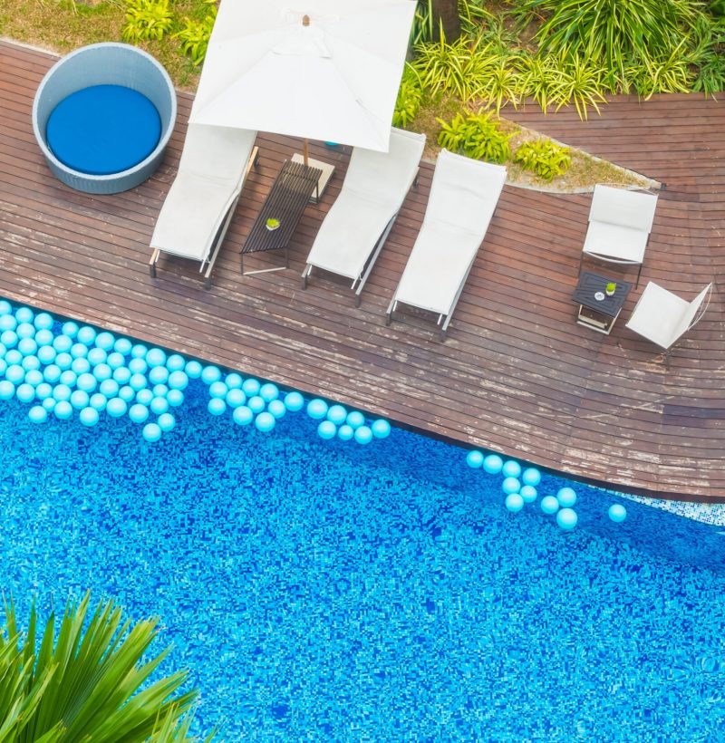 Aerial view of Beautiful luxury hotel swimming pool resort with umbrella and chair - Boost up color processing