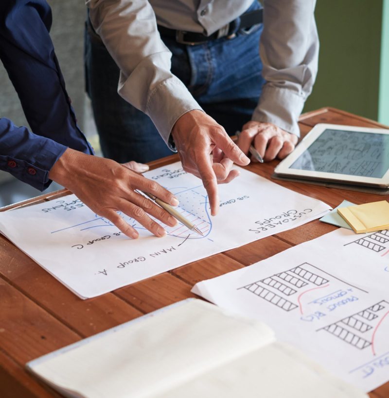 Business team drawing charts and graphs to make a report