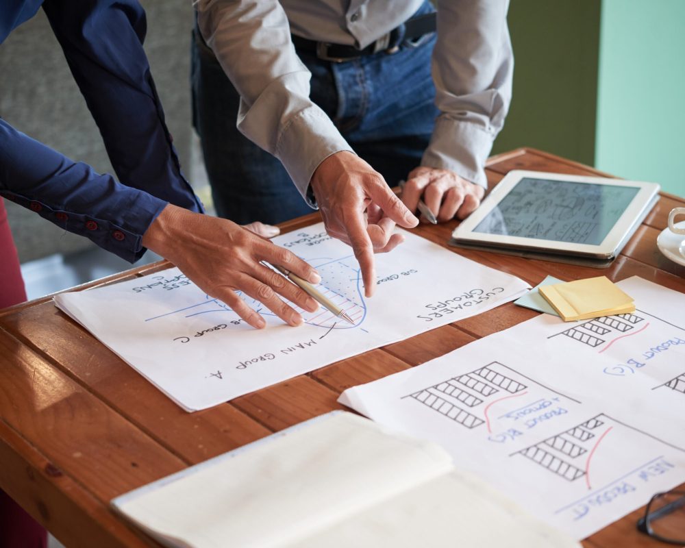 Business team drawing charts and graphs to make a report