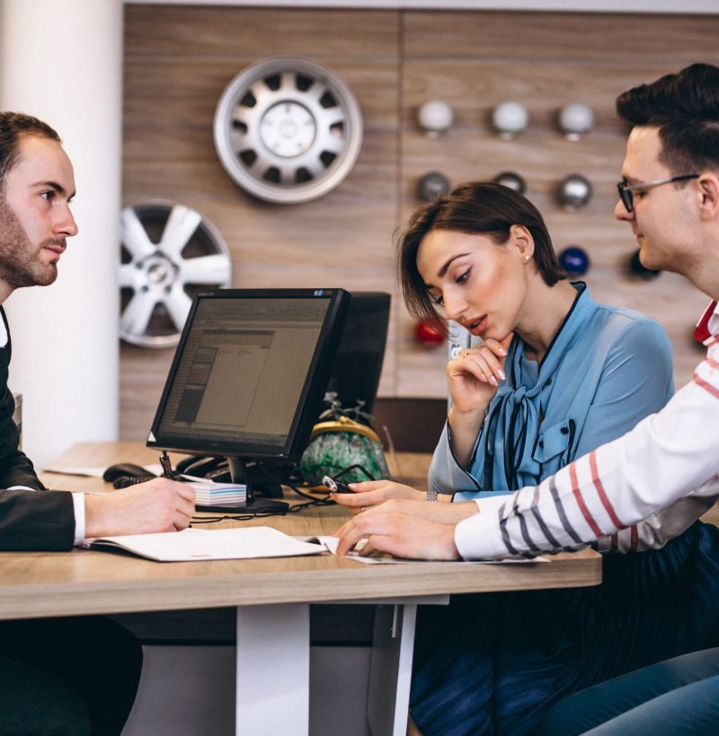 Family buying a car at a dealer