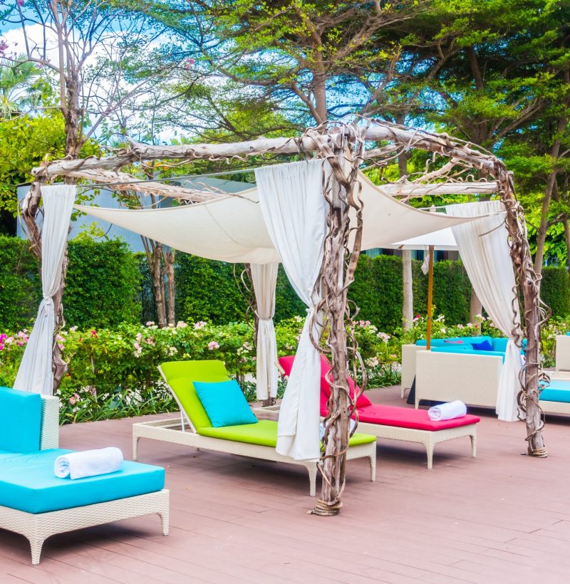 Umbrella and chair around swimming pool in beautiful luxury hotel resort for holiday vacation concept background